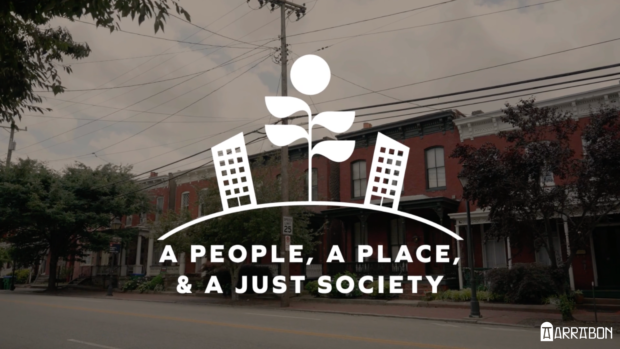 Logo for A People, A Place, and a Just Society laid over a city street.